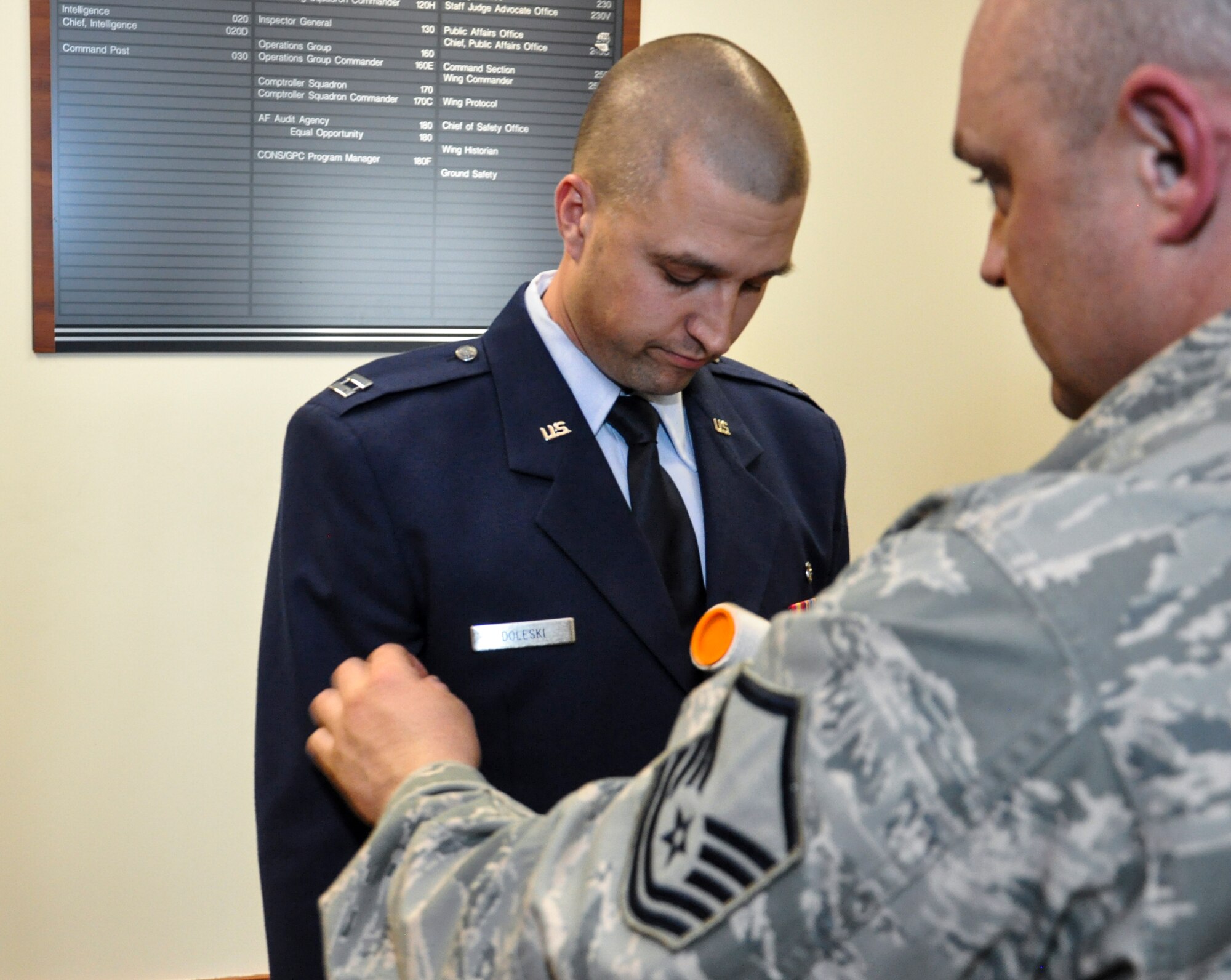 Master Sgt. Jody Brown, 460th Medical Group, right, helps prepare Capt. John Doleski, 460th MDG company grade officer category annual award nominee, uniform before meeting the annual award board Jan. 27, 2014, at the 460th Space Wing headquarters building on Buckley Air Force Base, Colo. All competitors met the annual awards board as part of their overall submission packages. (U.S. Air Force photo by Staff Sgt. Nicholas Rau/Released)