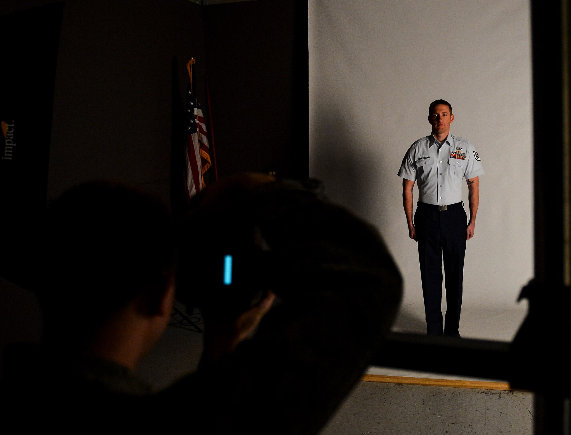 Tech. Sgt. Gregory Whittet, 460th Mission Support Group NCO category annual award nominee, takes his official photograph for his annual awards package submission Jan. 24, 2014, at the 460th Space Wing Public Affairs Office on Buckley Air Force Base, Colo. The photograph was one requirement for the annual awards competition, which also included meeting a board of four Buckley chief master sergeants. (U.S. Air Force photo by Staff Sgt. Nicholas Rau/Released)