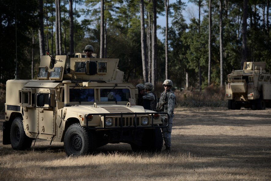 Members of the 822nd Base Defense Squadron stand by as protesters approach the forward operating base perimeter during the EXERCISE SAFESIDE GUARDIAN, Jan. 27, 2014, at Moody Air Force Base, Ga. Throughout the week, Airmen encountered various unexpected scenarios they could face downrange. (U.S. Air Force photo by Airman 1st Class Sandra Marrero/Released)