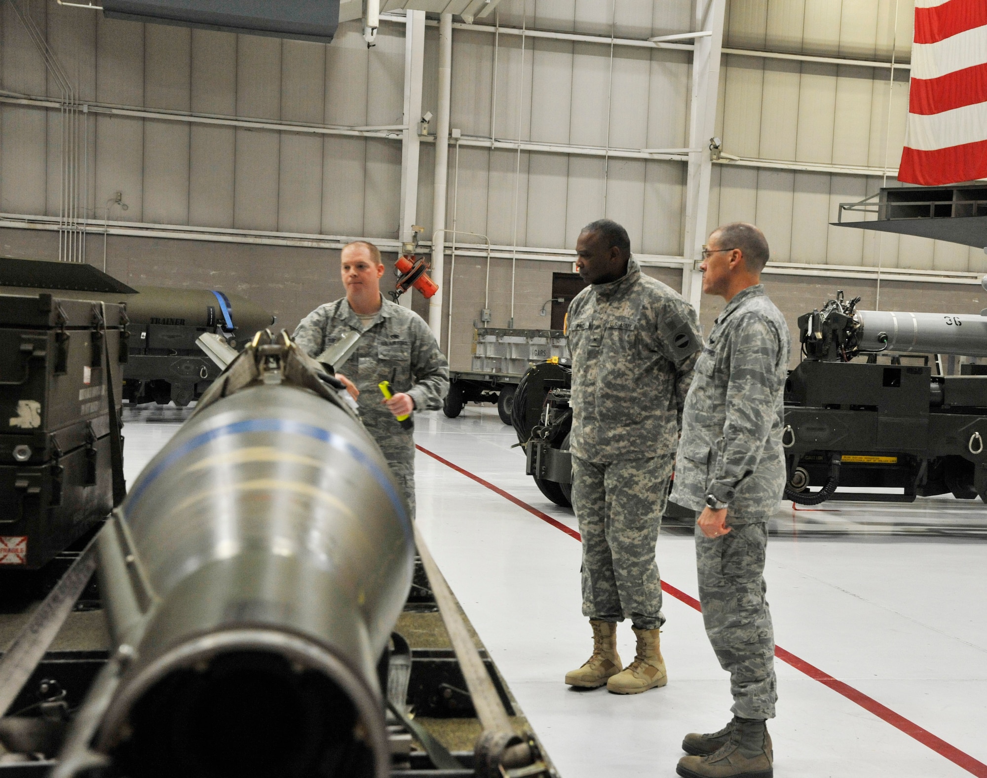 Tech. Sgt. Joseph Dubose, 509th Maintenance Group loading standardization crew member, briefs Brig. Gen. Barrye Price, U.S. Army Forces Command deputy chief of staff, on weapons load trainers at Whiteman Air Force Base, Mo., Jan. 29, 2014. During his tour, Price visited the 509th Aircraft Maintenance Squadron/13th Aircraft Maintenance Unit and the 509th MXG, and concluded with giving a speech at the Martin Luther King Luncheon. (U.S. Air Force photo by Airman 1st Class Keenan Berry/Released)