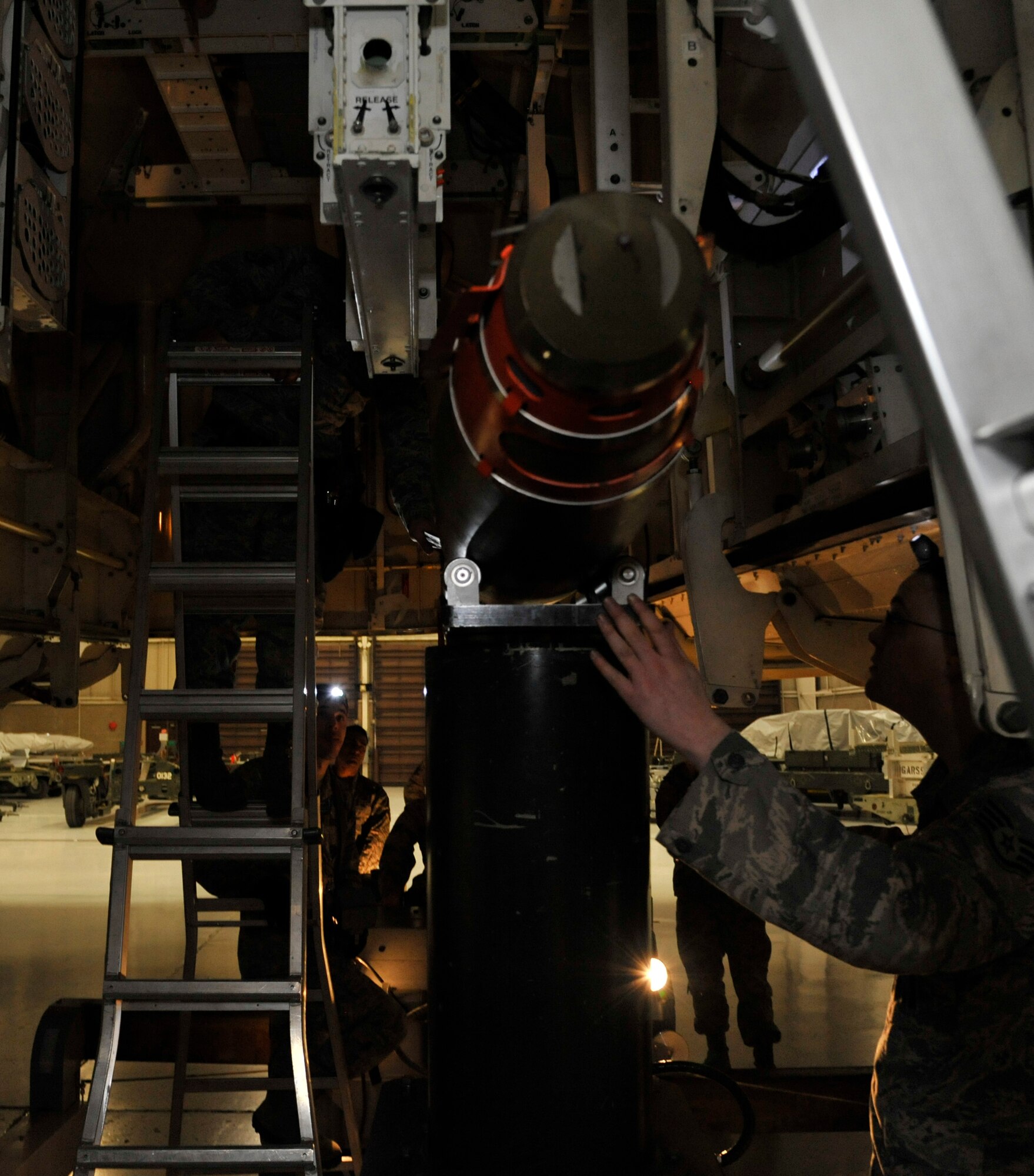 509th Maintenance Group/ 393rd Aircraft Maintenance Unit crew 3 loads weapon during the 2013 Weapons Load Crew Competition of the Year at Whiteman Air Force Base, Mo., Jan. 24, 2014. After completion of the final load, the weapons section superintendent will provide the WS NCO in charge and competing team chiefs with a list of discrepancies, allowing time 30 minutes to arbitrate them. The WS superintendent ensures that the WS NCO in charge of each load crew receives a copy of the score sheet and discrepancies immediately following the winner’s announcement. (U.S. Air Force photo by Airman 1st Class Keenan Berry/Released)