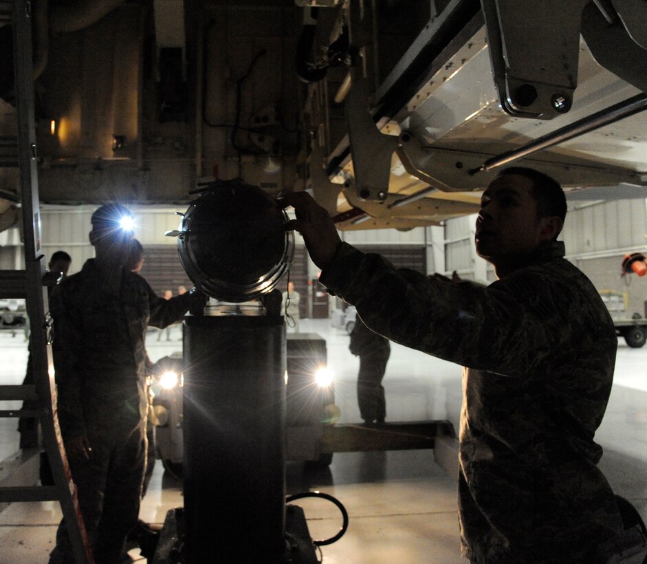 The 131st Maintenance Group/ 393rd Aircraft Maintenance Unit crew 1 prepares to load a weapon during the 2013 Weapons Load Crew Competition of the Year at Whiteman Air Force Base, Mo., Jan. 24, 2014. The objective of the competition is to load the weapon as quickly as possible with the least amount of discrepancies while competing against two other crews. (U.S. Air Force photo by Airman 1st Class Keenan Berry/Released)