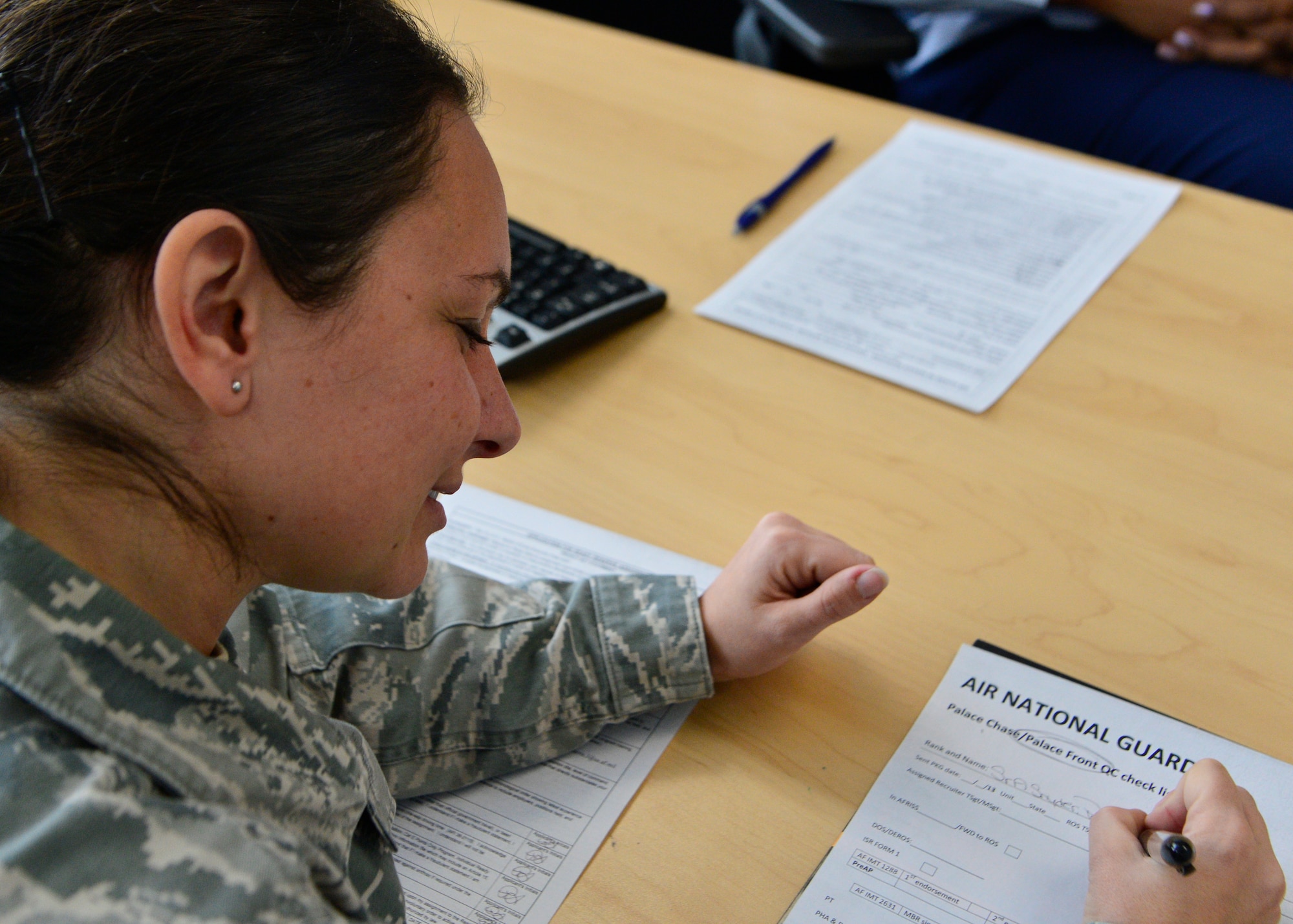 Senior Airman Patricia Snyder, 436th Comptroller Squadron quality assurance manager, fills out an application into the Palace Front program Jan. 31, 2014, at Dover Air Force Base, Del. Snyder opted to enlist in the Air National Guard instead of facing retention boards at her six-year enlistment mark. (U.S. Air Force photo/Airman 1st Class William Johnson)