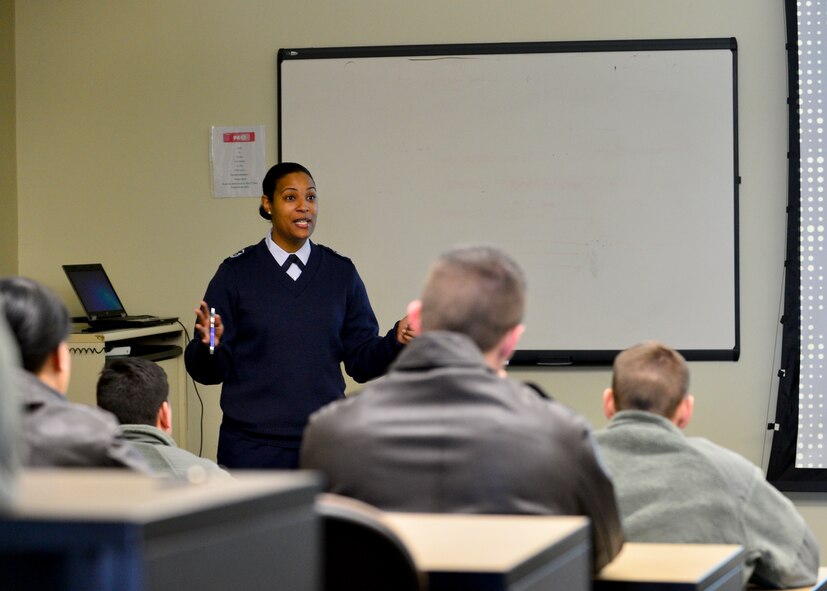 Master Sgt. Valerie Harris, Air National Guard in-service recruiter, briefs a room of Airmen about the Palace Chase and Palace Front programs Jan. 24, 2014, at Dover Air Force Base, Del. The two programs are pathways for Airmen to exit active duty status and join the ANG or Air Force Reserves. (U.S. Air Force photo/Airman 1st Class William Johnson)