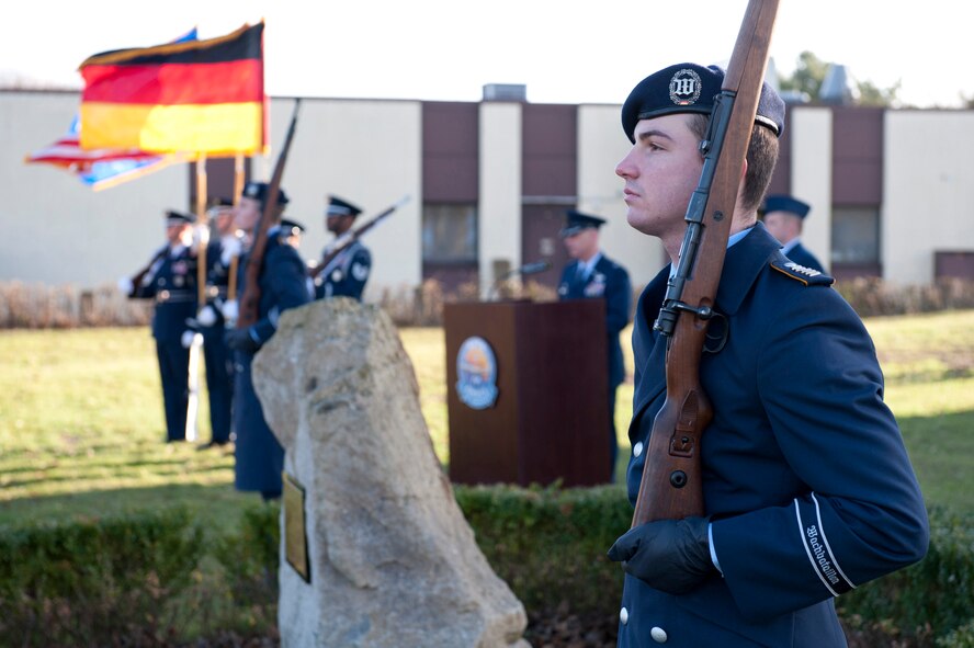 A member of the German Wachbataillon (Federal Defense Drill Team) based out of Berlin, Germany provides honors at the memorial for the crew of "ESSO 77" in Geilenkirchen, Germany, Jan. 10, 2014. The memorial pays tribute to four 141st Air Refueling Wing Airmen who lost their lives in the KC-135E Stratotanker crash on Jan. 13, 1999. (NATO E-3 component photo by Mr André Joosten/Released) 
