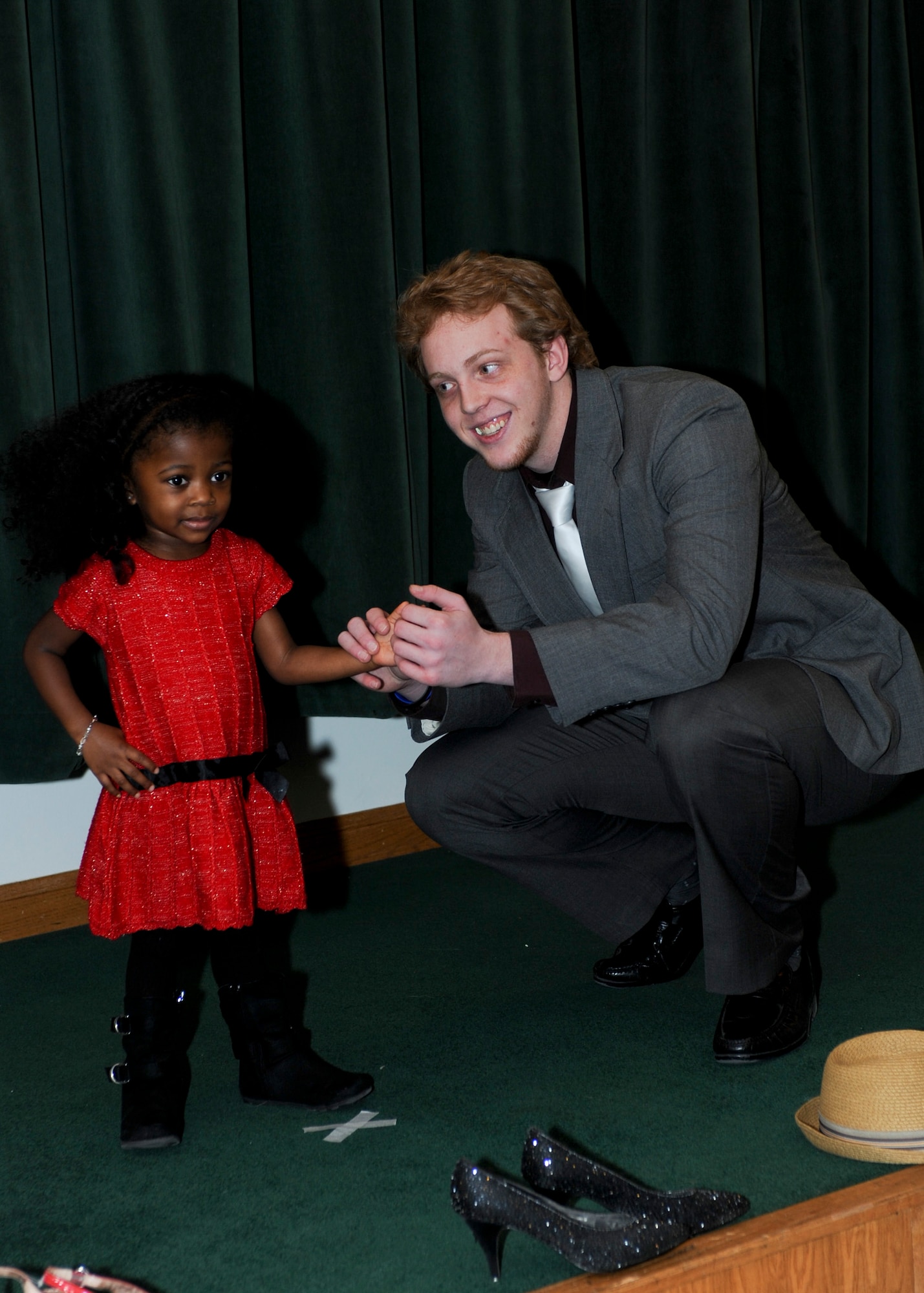 Colin Eiman escorts Nylah Winkfield on the walkway during the B-One Yard Thrift Store Volunteer Appreciation Dinner and Fashion Show in the Chapel Activities Center on Ellsworth Air Force Base, S.D., Jan. 28, 2014. The fashion show highlighted the many items available to Airmen at the B-One Yard Thrift Store while also providing an appreciation night for its volunteers. (U.S. Air Force photo by Senior Airman Anania Tekurio/Released) 