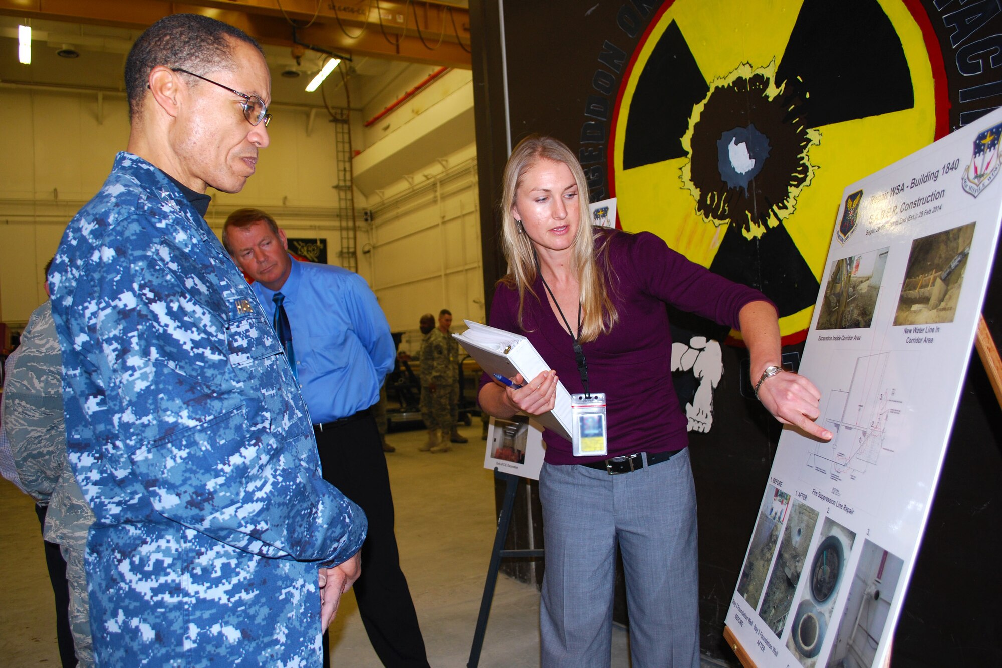 Adm. Cecil D. Haney, U.S. Strategic Command commander, listens to Jennifer Regel, 341st Civil Engineer Squadron civil engineer, discuss a construction project of Bldg. 1840 at the Weapons Storage Area at Malmstrom Air Force Base on Jan. 30. Haney’s tour of Malmstrom was the latest in a series of ongoing Air Force Global Strike Command base visits to meet with Airmen who contribute to the nuclear deterrence mission as part of his larger initiative to visit all contributors to the nation’s nuclear mission in the first year of command. (U.S. Air Force photo/Senior Airman Katrina Heikkinen)