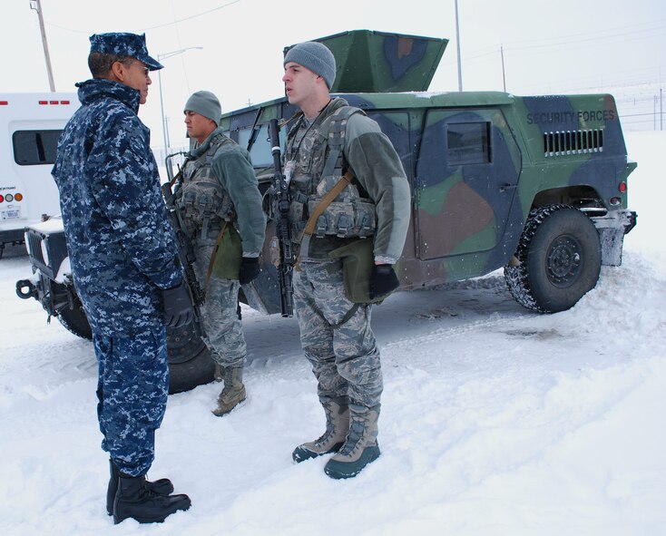 Airman 1st Class Blake Hunter (right) and Airman Jacob Yates, both 341st Security Forces Squadron members, give Adm. Cecil D. Haney, U.S. Strategic Command commander, a post brief at the Weapons Storage Area at Malmstrom Air Force Base,  Mont., on Jan. 30. Haney visited Malmstrom to meet with Team Malmstrom members who support the Air Force’s nuclear enterprise as part of his larger initiative to visit all contributors to the nation’s nuclear mission in the first year of command. (U.S. Air Force photo/Senior Airman Katrina Heikkinen)