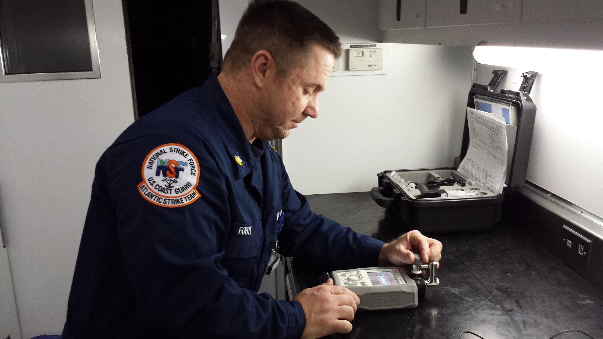 Coast Guard Petty Officer 1st Class Rich Forte, Atlantic Strike Team member, calibrates and tests chemical identification equipment before a possible response prior to assisting with security operations at Super Bowl XLVIII Jan. 30, 2014, in East Rutherford, N.J.