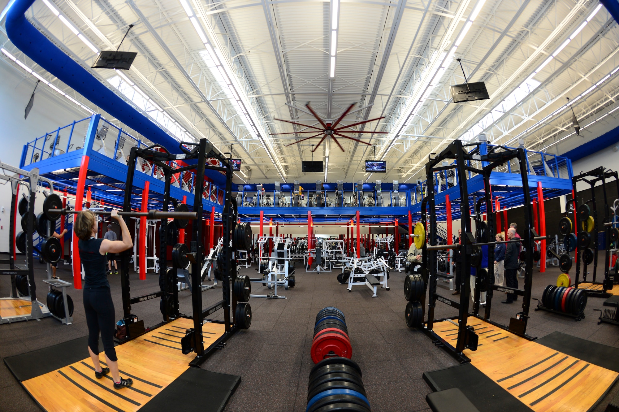 Short Fitness Center’s patrons workout in the newly renovated free weight room at MacDill Air Force Base, Fla., Jan. 31, 2014. The free-weight room remained virtually the same housing 25,000 pounds of weights; however, the cardio equipment is now located on the new u-shaped, second floor mezzanine. (U.S. Air Force photo by Senior Airman Shandresha Mitchell/ Released)