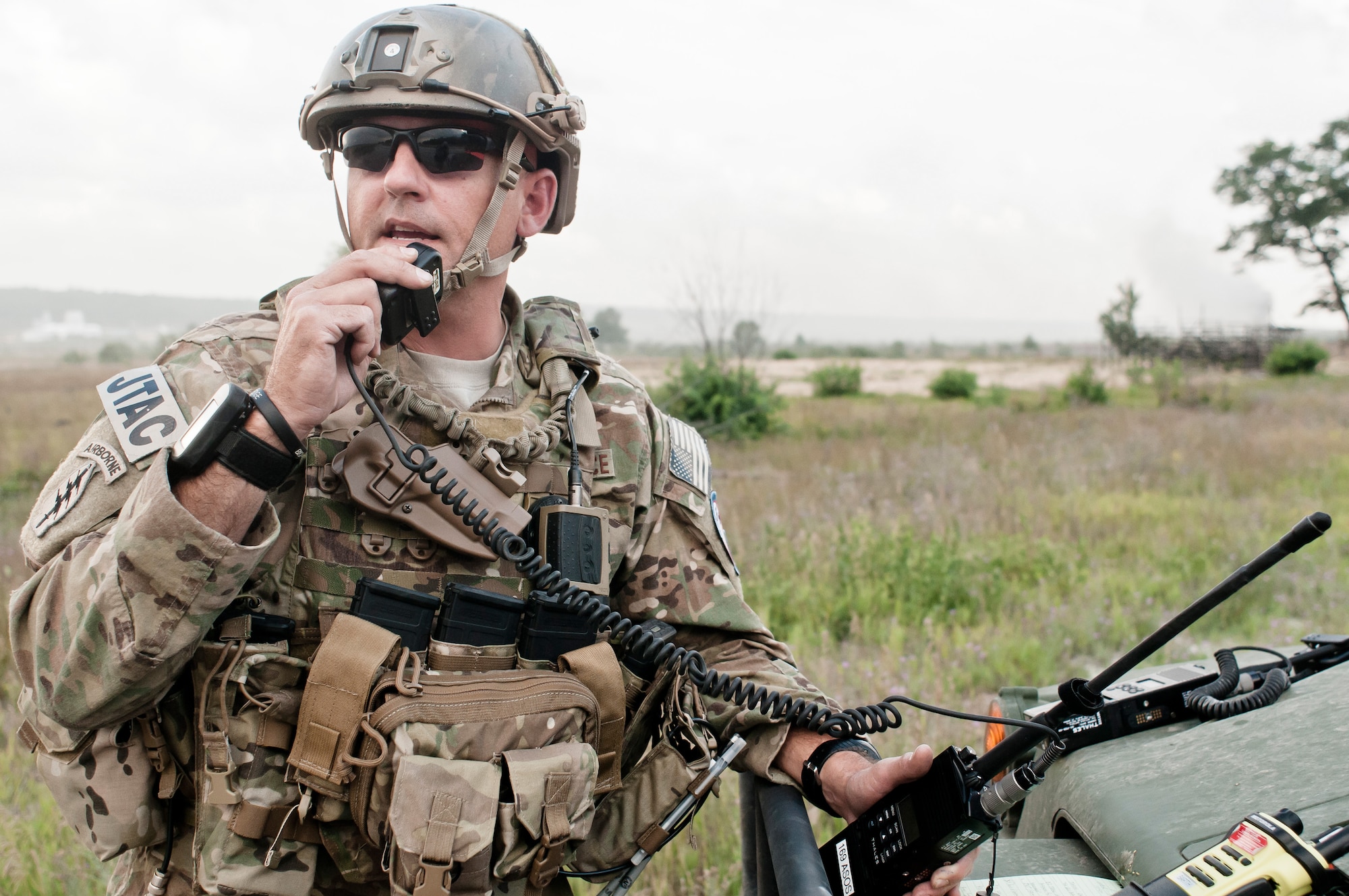 U.S. Air Force Master Sgt. Chuck L. Barth, a tactical air control party specialist with the 182nd Air Support Operations Group, speaks with a C-130 Hercules at Grayling Gunnery Range on a deployment of a training bundle during Exercise Northern Strike 2013 in Grayling, Mich., Aug. 6, 2013. Exercise Northern Strike 2013 is a joint multi-national combined arms training exercise conducted in northern Michigan. (U.S. Air National Guard photo by Master Sgt. Scott Thompson/released)