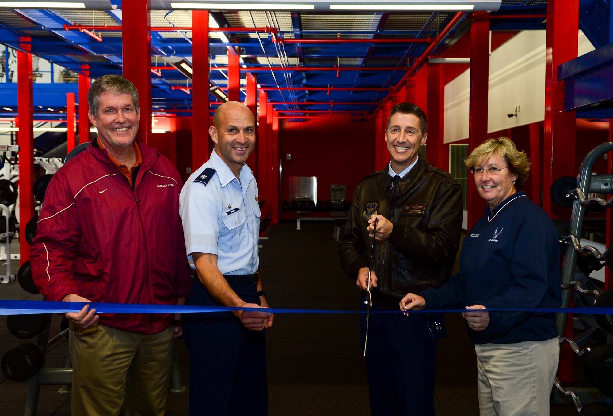 From left, Michael Cooley, 6th Civil Engineer Squadron chief of construction programs, Lt. Col. Sean Jones, 6th Force Support Squadron commander, Col. Scott DeThomas, 6th Air Mobility Wing commander, Charlotte Alexander, 6th FSS fitness center director, cut the ribbon during the mezzanine ribbon cutting ceremony at the Short Fitness Center on MacDill Air Force Base, Fla., Jan. 31, 2014. (U.S. Air Force photo by Senior Airman Shandresha Mitchell/ Released)