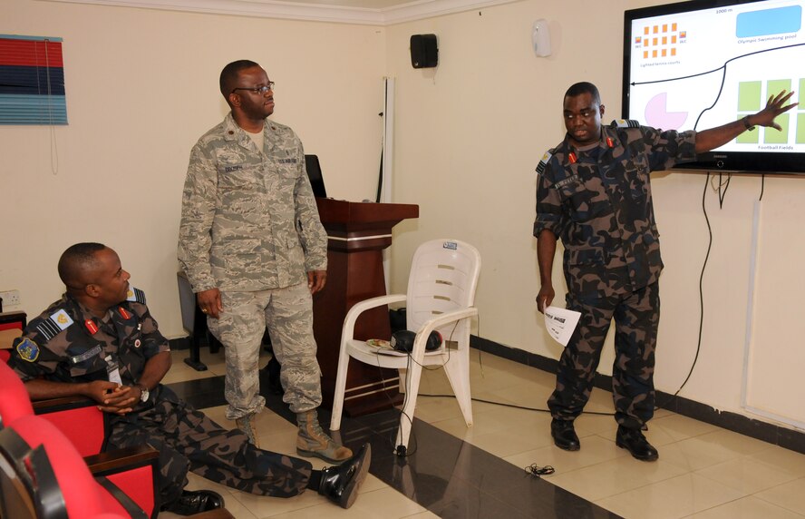 Maj. Francis Obuseh, U.S. Air Forces in Europe-Air Forces Africa Surgeon General directorate, doctor of public health, discusses medical considerations with members of the Nigerian air force during a crisis planning scenario. The Nigerian air force partnered with USAFE-AFAFRICA, the 621st Contingency Response Wing, and U.S. Africa Command to host a disaster relief planning seminar at the National Defense College in Abuja, Nigeria, Jan 27-30. (U.S. Air Force photo/Capt. Sybil Taunton)