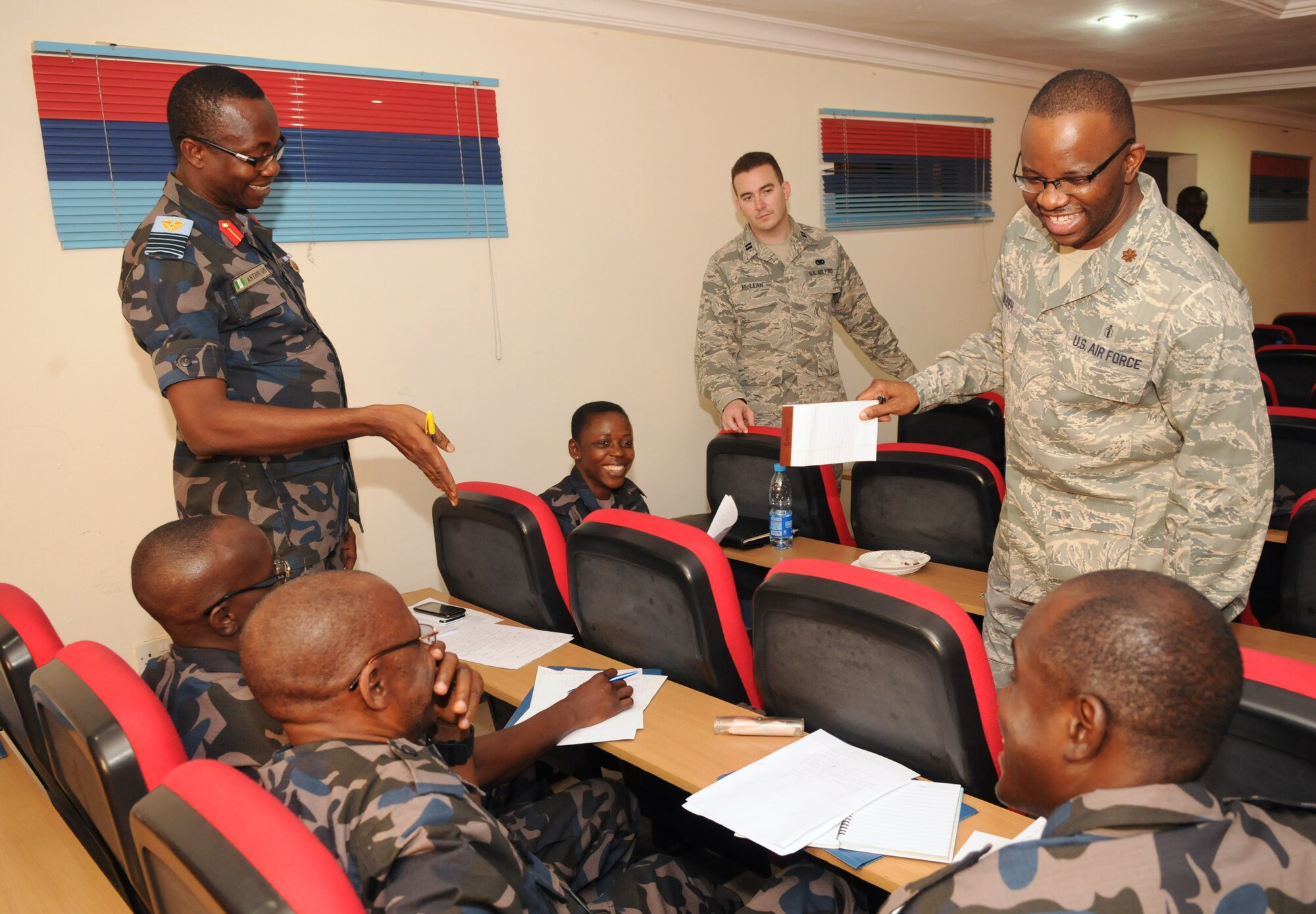 ABUJA, Nigeria – Members of the Nigerian air force laugh along with Maj. Francis Obuseh, a doctor of public health for the U.S. Air Forces in Europe-Air Forces Africa Surgeon General directorate, as he tells a story about one of his traveling experiences. The Nigerian air force partnered with USAFE-AFAFRICA, the 621st Contingency Response Wing, and U.S. Africa Command to host a disaster relief planning seminar at the National Defense College in Abuja, Nigeria, Jan 27-30. (Photo by U.S. Air Force Capt. Sybil Taunton/Released)