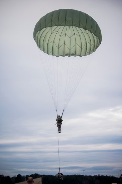 U.S. Air Force Senior Airman David Rodriguez, 822nd Base Defense Squadron radio transmitter operator, prepares to land during a static-line jump Jan. 24, 2014, at Moody Air Force Base, Ga. The jump was part of EXERCISE SAFESIDE GUARDIAN and simulated the unit tactically entering foreign territory. (U.S. Air Force photo by Staff Sgt. Jamal D. Sutter/Released)