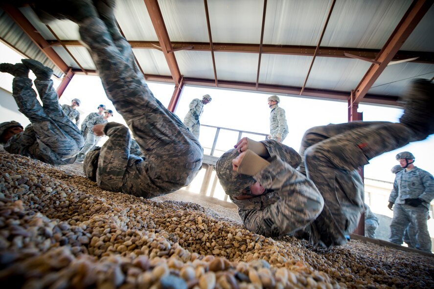 Airmen from the 822nd Base Defense Squadron participate in parachute landing fall training Jan. 24, 2014, at Moody Air Force Base, Ga. The training was in preparation for a static-line jump they later performed during EXERCISE SAFESIDE GUARDIAN. (U.S. Air Force photo by Staff Sgt. Jamal D. Sutter/Released)