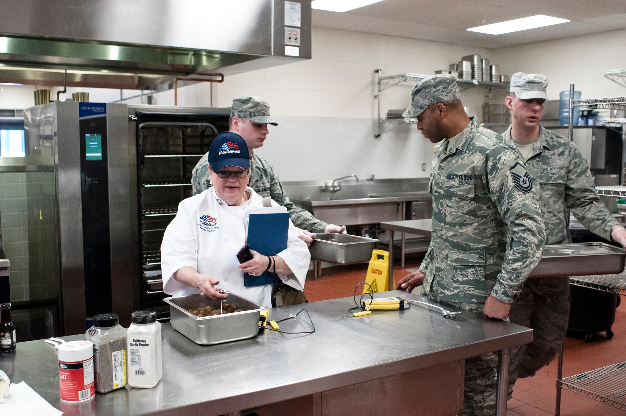 Evaluators from the Kenneth Disney Award examine the 182d Services Flight during a lunch service at the 182nd Airlift Wing, Peoria, Ill. on Feb. 1, 2014. The Services Flight was one of three units being evaluated for the award. (U.S. Air National Guard photo by Master Sgt. Scott Thompson (released))