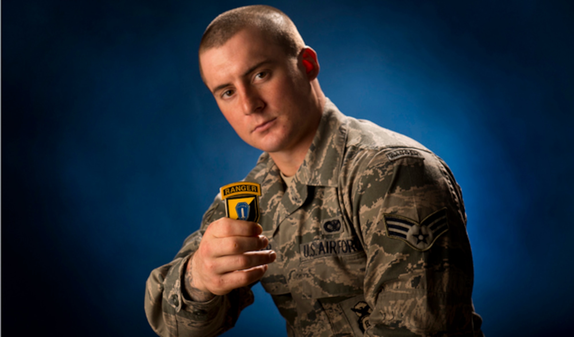 Senior Airman Stephen Becker holds a commander's coin from the U.S. Army Ranger School Jan. 31, 2014, at Joint Base Elmendorf-Richardson, Alaska. Becker is the 257th Airman to graduate from the U.S. Army Ranger School at Ft. Benning, Ga. The purpose of the school is to develop combat skills of selected officers and enlisted men by requiring them to perform effectively as small unit leaders in a realistic tactical environment, under mental and physical stress approaching that found in actual combat. (U.S. Air Force photo/Justin Connaher)