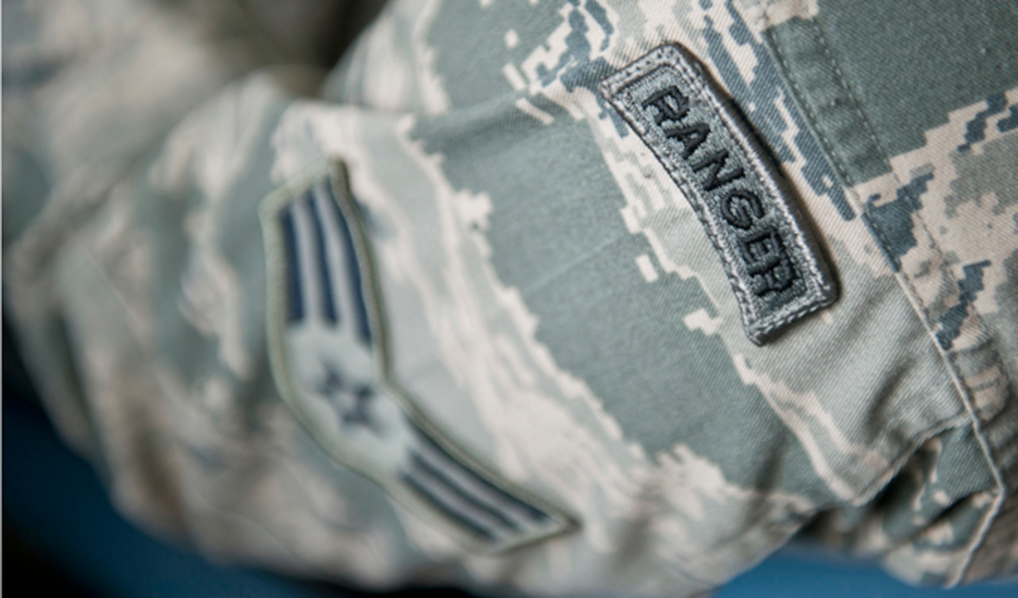 Senior Airman Stephen Becker proudly displays his Ranger tab above his rank insignia, while he talks about the leadership skills he developed during Ranger school Jan. 31, 2014, at Joint Base Elmendorf-Richardson, Alaska. Becker is only the 257th Airman to graduate from the U.S. Army Ranger School at Ft. Benning, Ga. The purpose of the school is to develop combat skills of selected officers and enlisted men by requiring them to perform effectively as small unit leaders in a realistic tactical environment, under mental and physical stress approaching that found in actual combat. (U.S. Air Force photo/Justin Connaher)