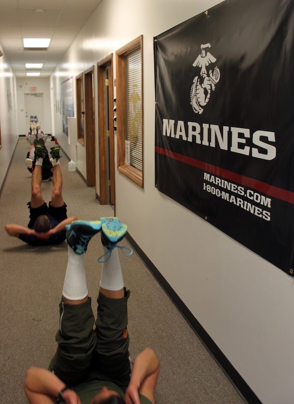 U.S. Marine Corps Pvt. Nisa Jovel (at bottom), leads pool physical fitness indoors during inclement weather in Frederick, Md., Jan. 30, 2014. Jovel is on 10-day boot leave and is getting her first taste of leading Marines by volunteering her time with Recruiting Sub-station Frederick.  (U.S. Marine Corps photo by Sgt. Amber Williams/Released)