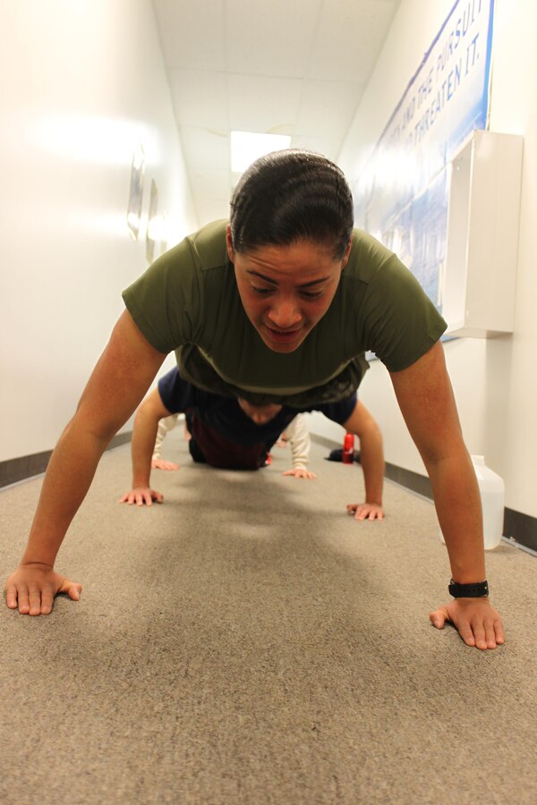 U.S. Marine Corps Pvt. Nisa Jovel leads squad push-ups during pool physical fitness indoors during inclement weather in Frederick, Md., Jan. 30, 2014. Jovel is on 10-day boot leave and is getting her first taste of leading Marines by volunteering her time with Recruiting Sub-station Frederick. (U.S. Marine Corps photo by Sgt. Amber Williams/Released)