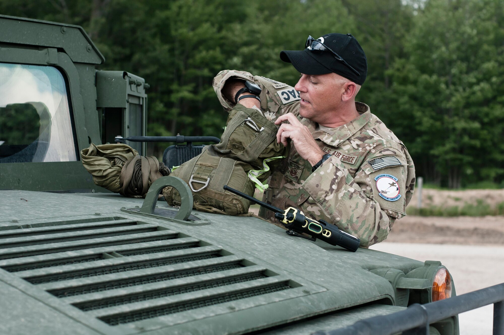 Master Sgt Chuck Barth checks a training bundle from an airdrop with a C-130 Hercules at Grayling Gunnery Range during Exercise Northern Strike 2013 on August 6, 2013.Exercise Northern Strike 2013 is a joint multi-national combined arms training exercise conducted in Michigan. (U.S. Air National Guard photo by Master Sgt. Scott Thompson/unclassified)