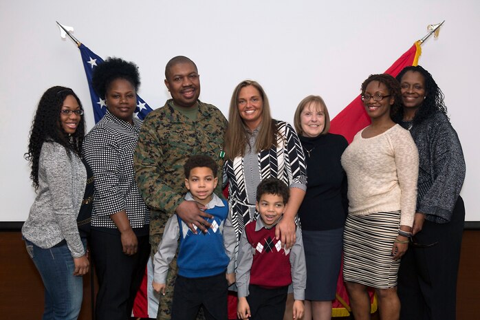 Gunnery Sgt. Devon M. Smith stands with his family after he and they were honored during his retirement ceremony at U.S. Marine Corps Forces Command on Jan. 31, 2014. Smith faithfully served on active duty for 21 years. Visit http://www.flickr.com/photos/marforcom/sets/72157640354007146/ for additional photos.