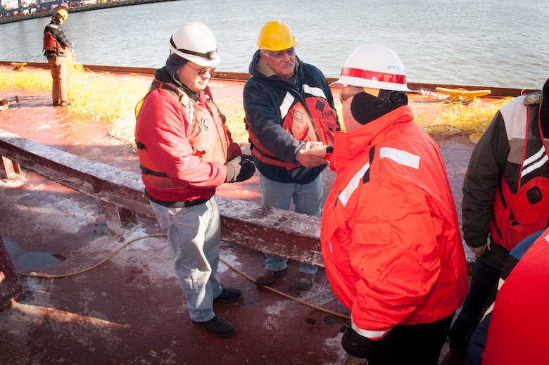 Under Secretary of the Army Joseph W. Westphal (right) thanks personnel aboard a drill boat while receiving a first-hand look at drilling and blasting operations being performed in the Arthur Kill Channel of the New York Container Terminal, Staten Island and Elizabeth, N.J., in January 2014. Westphal met with leaders from the U.S. Army Corps of Engineers, North Atlantic Division and New York District to receive various updates regarding the Corps’ efforts post Hurricane Sandy and observe the Corps’ oversight of vital civil works projects. Once complete, the deepened channel will provide a safe and economically efficient pathway for the newest generation of container ships that will be calling at the Port of New York and New Jersey following the completion of the Panama Canal expansion in 2015.

Photo Credit: U.S. Army Staff Sergeant Bernardo Fuller 
