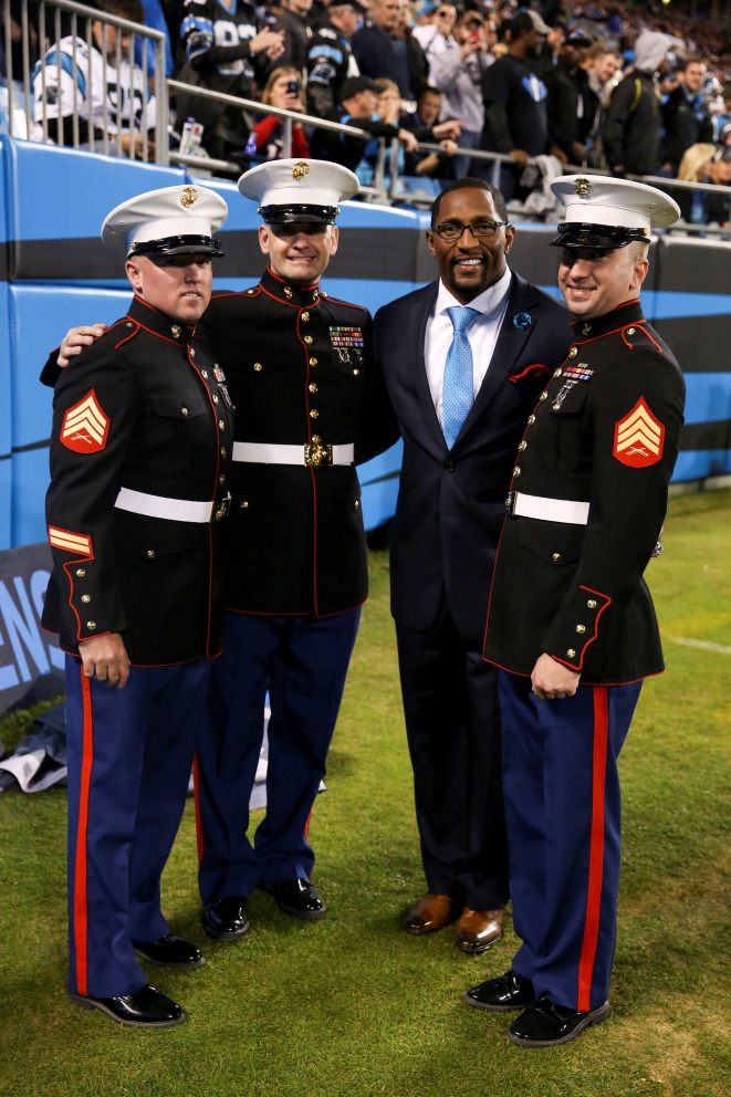 Gunnery Sgt. Sean Noumi (left) of Hall, Mass., leads a group of 10 Marines with 2nd Marine Division off the field at Bank of America Stadium following a mass re-enlistment ceremony during the pregame presentation of a Carolina Panthers’ game Nov. 18, 2013. The NFL hosted the ceremony as part of their Salute to Service, where the NFL showed its appreciation for the men and women who serve our country. A re-enlistment ceremony is where services members raise their right hand and take the oath of enlistment pledging additional years of service to their country. Players posed for pictures at the Marines’ request as they headed off the field and before the ceremony.
