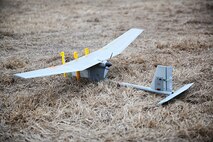 A Raven unmanned aerial vehicle rests on the ground prior to flight aboard Camp Lejeune, N.C., Feb. 4, 2014.  Marines with 2nd Marine Logistics Group have been training with the UAV for the past two weeks to maintain mission readiness. (U.S. Marine Corps photo by Lance Cpl. Shawn Valosin)