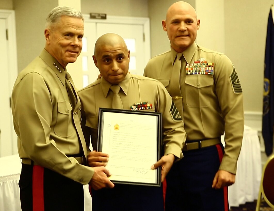 Gunnery Sgt. Victor Perez, prior service recruiter, 8th Marine Corps District, receives his promotion warrant after being meritoriously promoted by Gen. James F. Amos, Commandant of the Marine Corps, during a ceremony, here, Feb. 4. In  fiscal year 2013, Perez managed to recruit over 70 of the wise, skillful, knowledgeable prior serivce Marines the Mainre Corps hopes to keep. His dedication to recruiting earned him the title of Marine Corps Recruiting Command prior service recruiter of the year for FY13.
