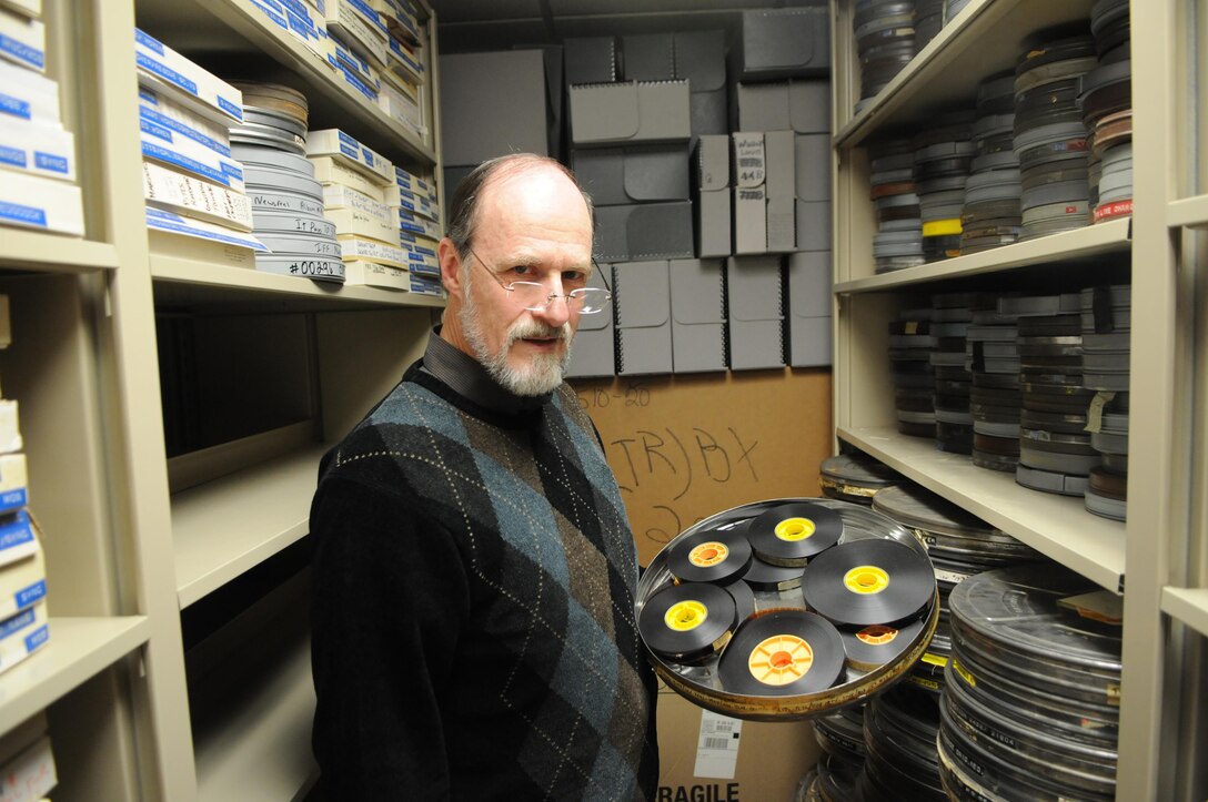 In the Oral and Video History Section stacks Jan. 24, 2014, collection manager Tom Baughn shows one of many 35-millimeter film canisters full of unlabeled 16-millimeter reels. Since taking over the branch more than a year ago, he and a colleague have worked to organize, document and digitize the section’s massive collection, but he expects to enlist the aid of the Library of Congress in the near future. 