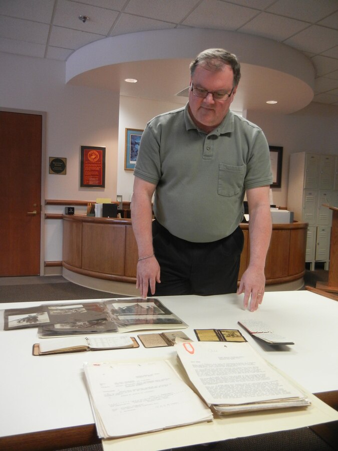 Jim Ginther, archival team leader for Archives and Special Collections Branch, looks over items from the personal collection of Lt. Col. Alfred Cunningham, the Marine Corps’ first pilot, on Jan. 23, 2014, in the branch’s office in the Gray Research Center. About half of the branch’s collection consists of around 5,800 personal collections from Marines throughout history. 