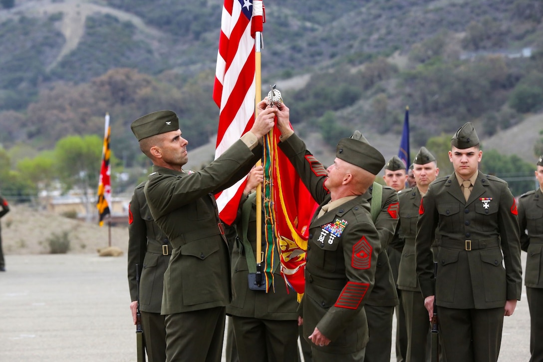 Col. Peter Baumgarten, left, commanding officer, 1st Marine Regiment, and a native of El Paso, Texas, rededicates the regiment’s battle streamers during a 100-year anniversary ceremony aboard Camp Pendleton, Calif., Jan 24, 2014. For the Marines, celebrating the 100th anniversary of the regiment honors all who have served and given their lives to make it what it is today.