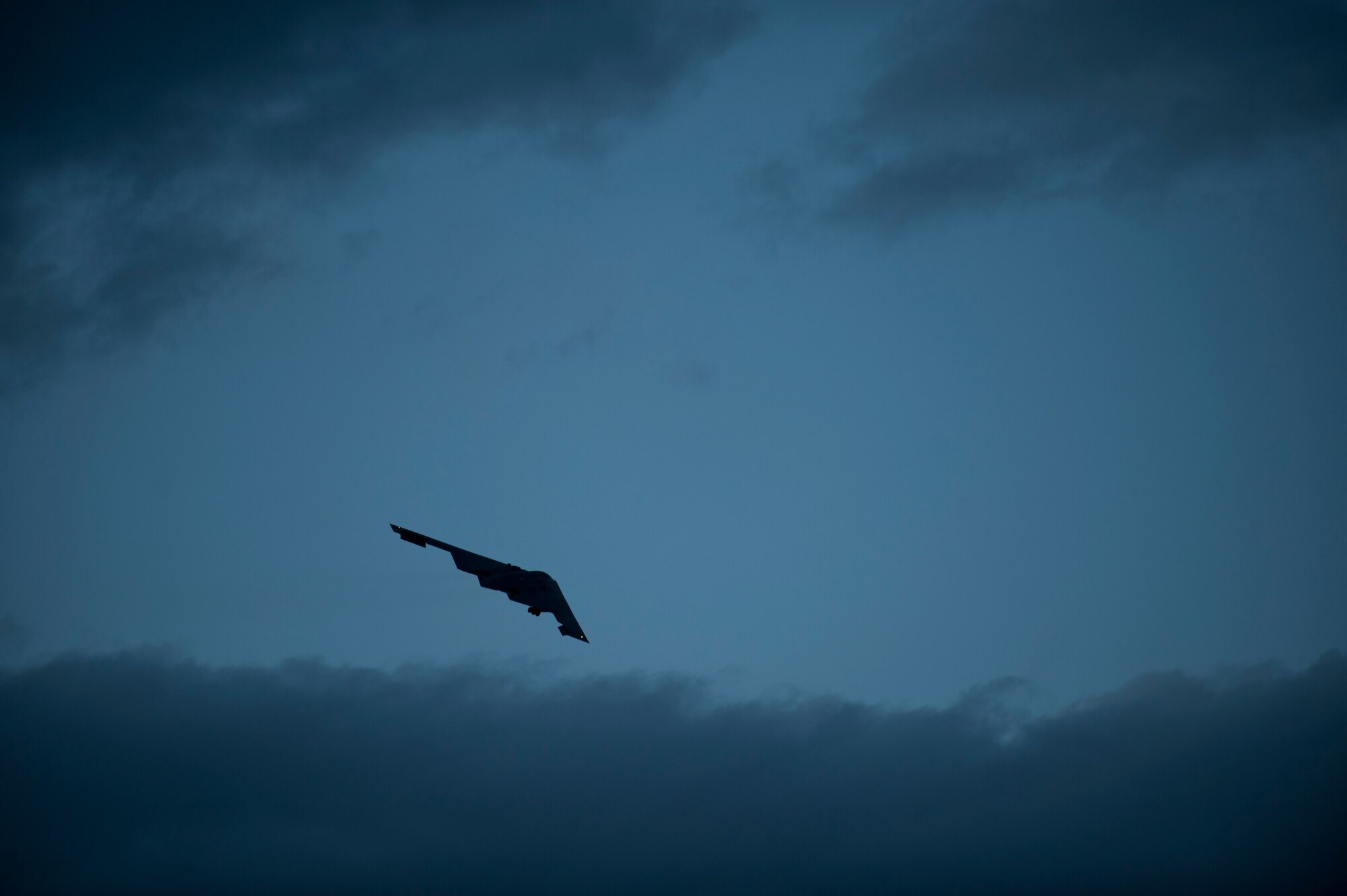 NELLIS AIR FORCE BASE, Nev. -- A B-2 Spirit from the 13th Bomb Squadron, Whiteman Air Force Base, Mo., banks over the flightline at Nellis AFB, Nev., during a Red Flag 14-1 night training mission Jan. 29, 2014. The B-2 is a multi-role bomber capable of delivering both conventional and nuclear munitions.  The 13 BS is participating in Red Flag to show what Global Strike stealth assets do when incorporated into the exercise’s mission planning.  Red Flag night missions present the additional challenge of low visibility, testing the aircrew’s ability to execute the mission at any hour in a contested and degraded environment. (U.S. Air Force photo by Airman 1st Class Joshua Kleinholz)