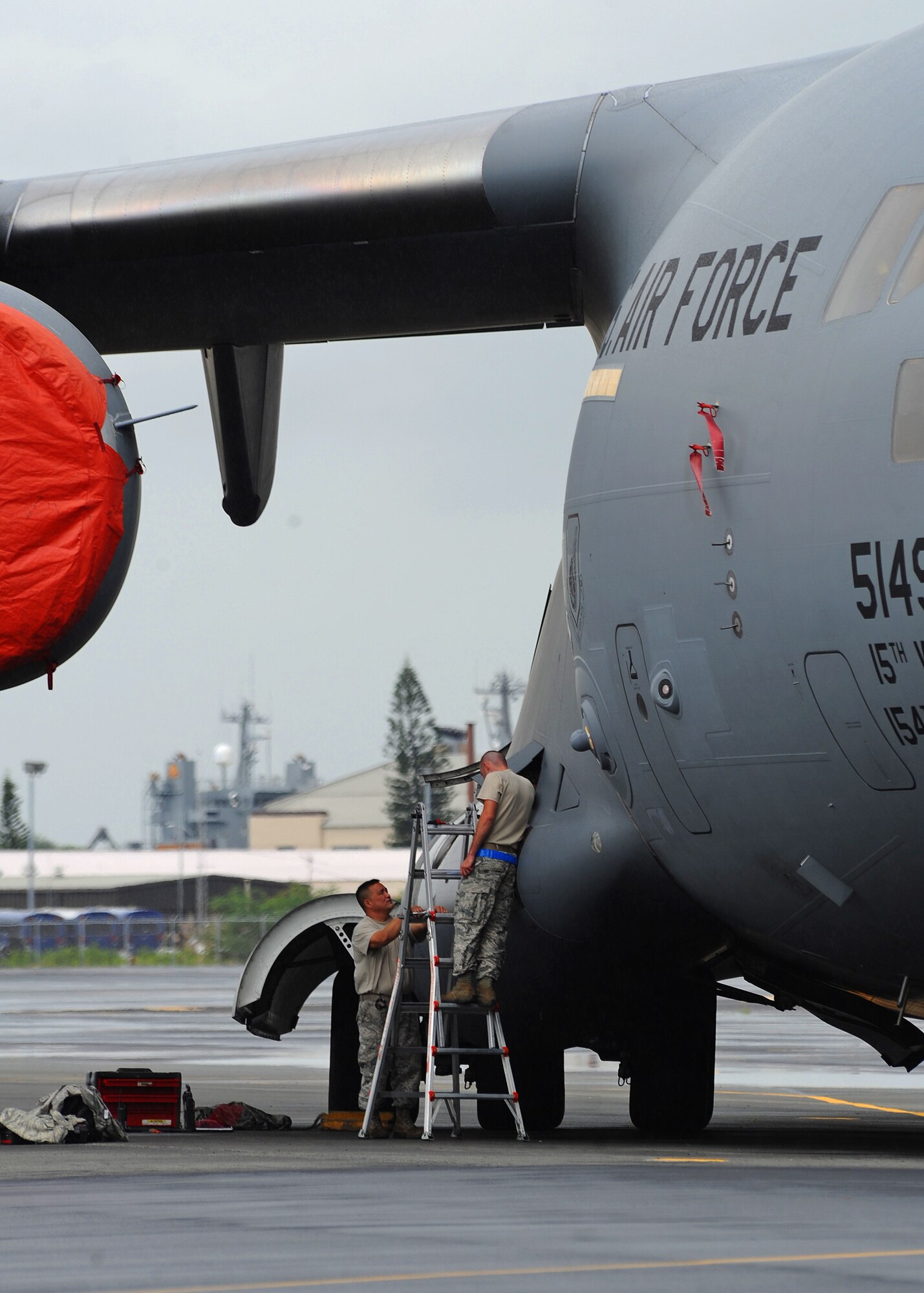 Airmen from the 15th Aircraft Maintenance Squadron prepare to replace an auxiliary power unit inlet door actuator on a C-17 Globemaster III on the flightline at Joint Base Pearl Harbor-Hickam, Hawaii, Feb. 4, 2014. The inherent flexibility and performance of the C-17 force improve the ability of the total airlift system to fulfill the worldwide air mobility requirements of the United States. (U.S. Air Force photo/Master Sgt. Jerome S. Tayborn)