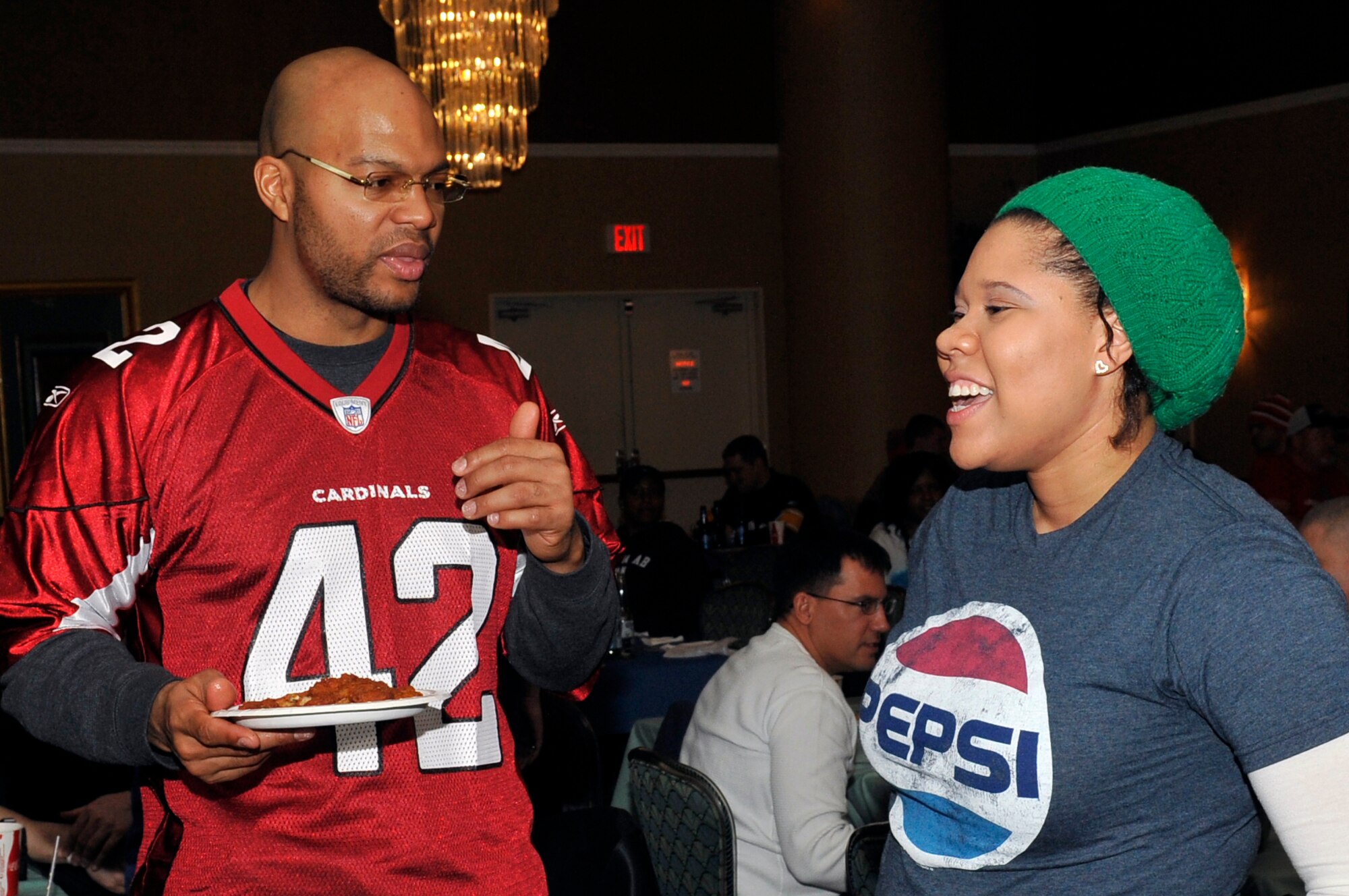 Terrence Holt, National Football League alumnus, talks to Staff Sgt. Ashley Elm, 301st Intelligence Squadron, during a Super Bowl XLVIII event at Misawa Air Base, Japan, Feb. 3, 2014. Eim and members of the Misawa community were able to watch the big game and get autographs from Holt and other members of the 2014 Super Bowl Tour. (U.S. Air Force photo by Airman 1st Class Zachary Kee)