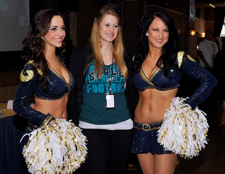 Staff Sgt. Sarah McGowan, 35th Fighter Wing protocol, poses for a photo with Dawn and Chelsea, St. Louis Rams cheerleaders, at a Super Bowl XLVIII event at Misawa Air Base, Japan, Feb. 3, 2014. The cheerleaders along with three National Football League alumni signed autographs, posed for photos and watched the game with members of the Misawa community. (U.S. Air Force photo by Airman 1st Class Zachary Kee)