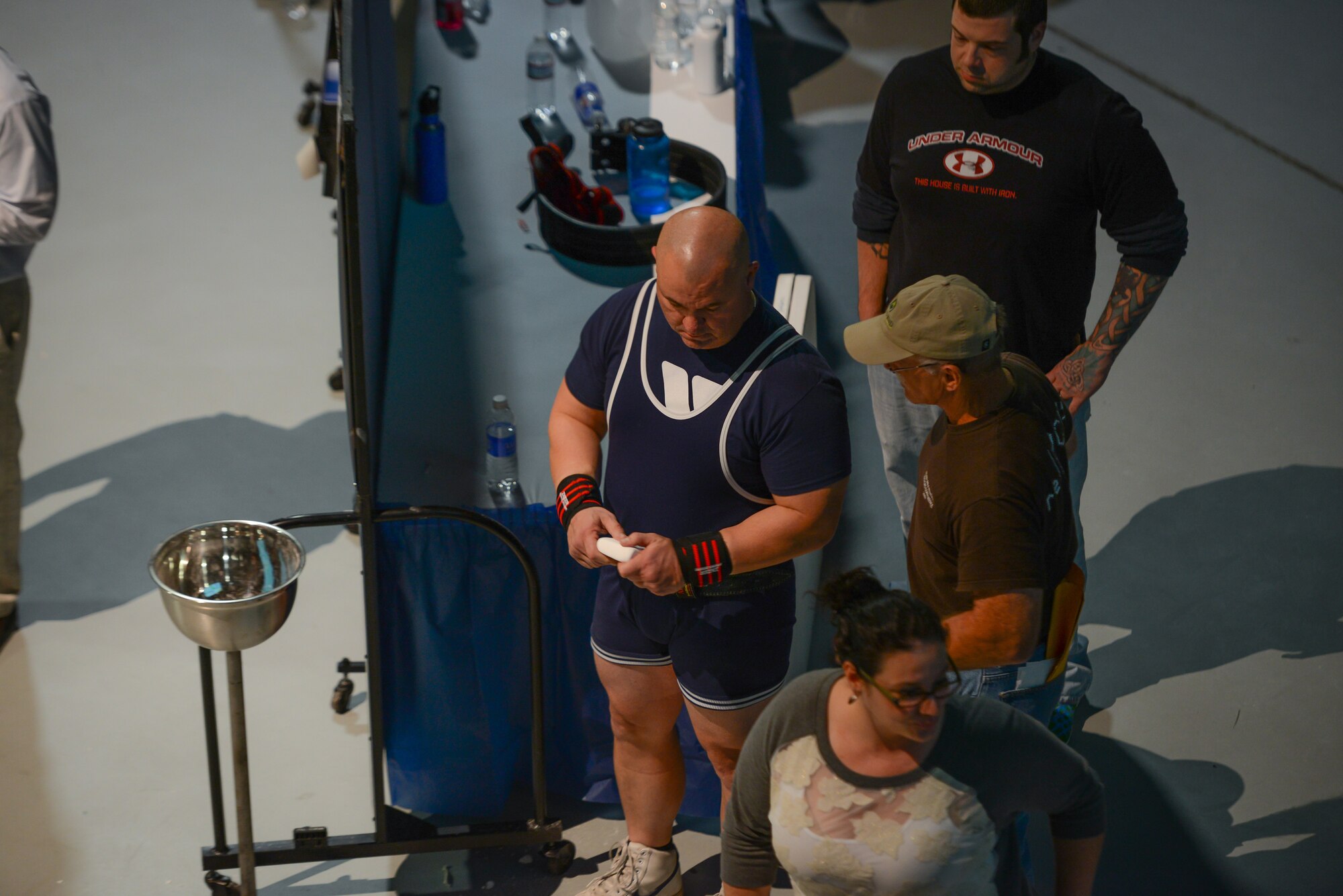 U.S. Air Force Tech. Sgt. Michael Lloyd of the 165th Airlift Wing, Georgia Air National Guard chalks his hands prior to attempting a bench press, Jan. 25, 2014, at the Museum of Aviation in Warner Robins, Ga. Lloyd broke four U.S.A. Powerlifting Georgia state records at the 2014 Winter Classic and Single Ply Invitational. He set a record for squat, bench press, three event total (squat, bench press, deadlift), and bench press only for the Masters Division in his weight class at his first powerlifting competition. (U.S. Air National Guard photo by Master Sgt. Charles Delano/Released)