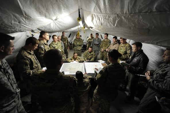 Airmen from Hurlburt Field and Cannon Air Force Base conduct joint air and ground de-confliction in preparation for the first day’s mission at Cannon AFB, N.M., Jan. 26, 2014. A team conducted planning as part of an emergency deployment readiness exercise. (U.S. Air Force photo/Staff Sgt. Jeff Andrejcik)