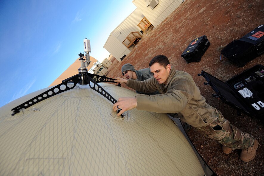 Airman 1st Class Brian Large, 1st Special Operations Communications Squadron radio frequency transmissions technician, assembles ground to air communication equipment at Cannon Air Force Base, N.M., Jan. 24, 2014. Airmen used the equipment in an emergency deployment readiness exercise. (U.S. Air Force photo/Staff Sgt. Jeff Andrejcik)