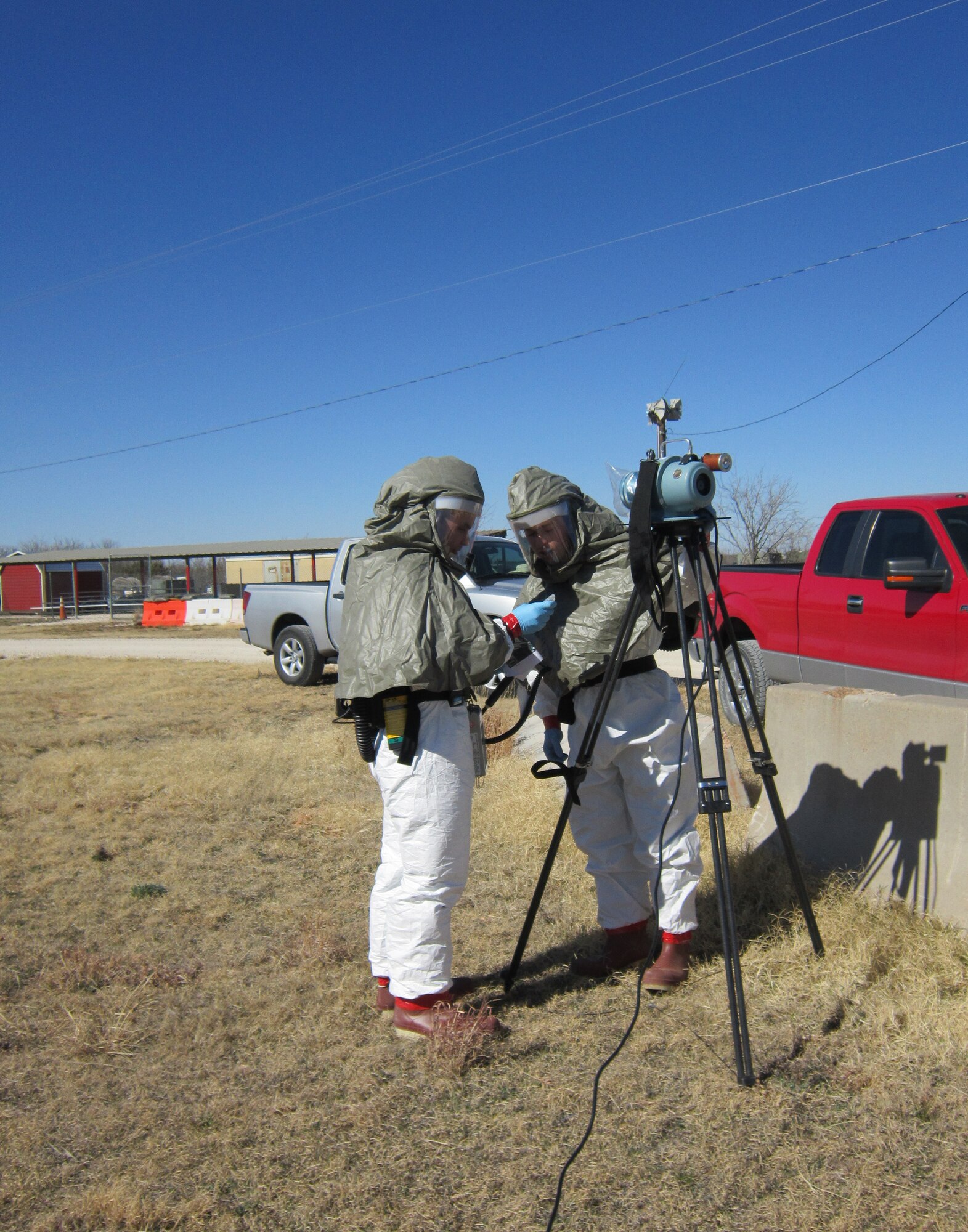 U.S. Air Force Staff Sgt. Lawrence Weathers, left, and Airman 1st Class Adam Disque, both from the 7th Aerospace Medical Squadron, assess radiological hazards using a radiation detection device during the 2013 Integrated Base Emergency Response Capabilities Training (IBERCT) Feb. 27, 2013, at Dyess Air Force Base, Texas. The training incorporated fire, emergency management and bioenvironmental engineering exercises. (Courtesy photo)