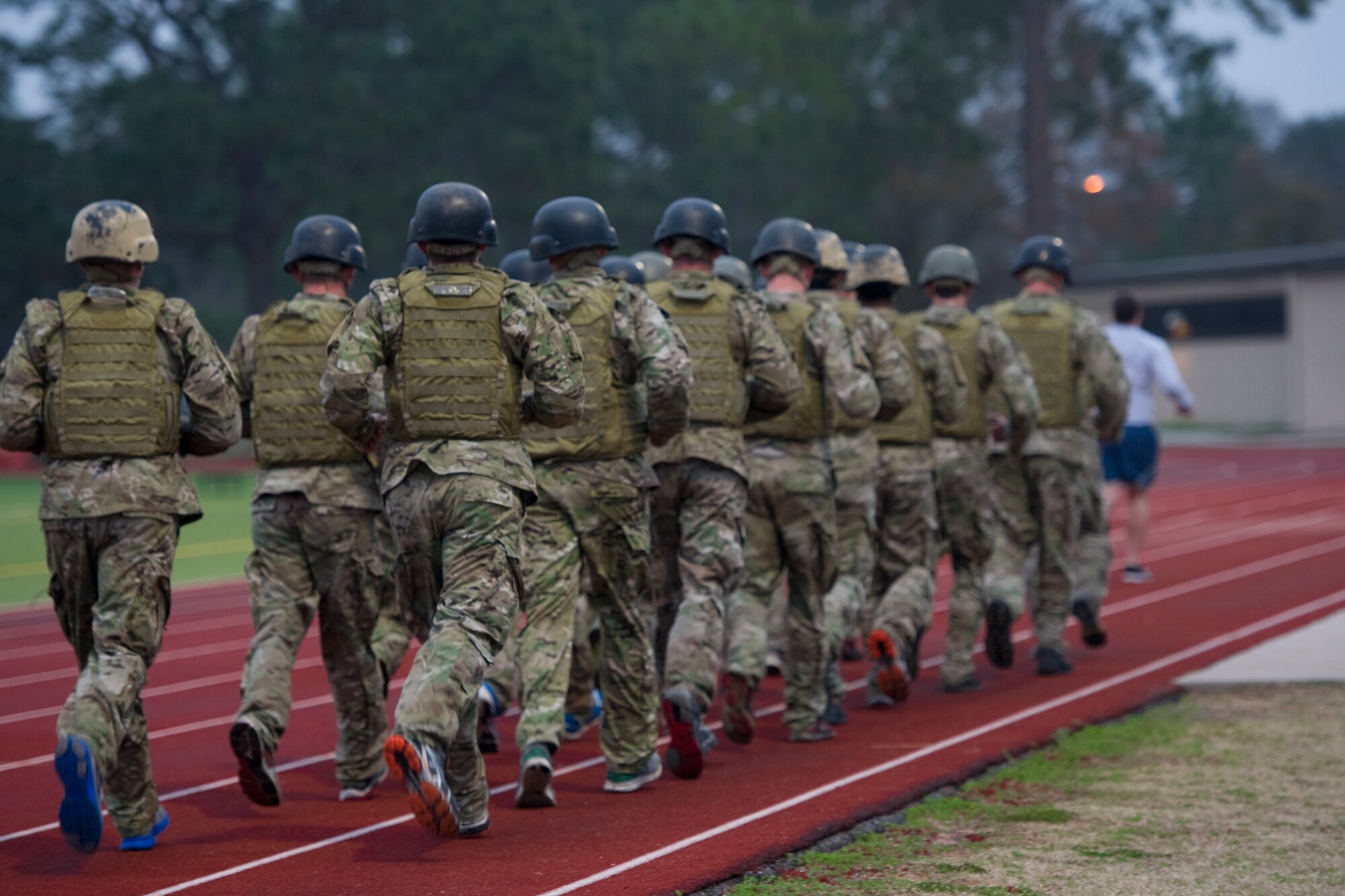 Tactical Air Control Party candidates run in formation on the track as part of their morning physical training at Hurlburt Field, Fla., Feb. 4, 2014. TACP candidates spend nearly five months in training here at Detachment 3, 342nd Training Squadron. (U.S. Air Force photo/Senior Airman Naomi Griego) 