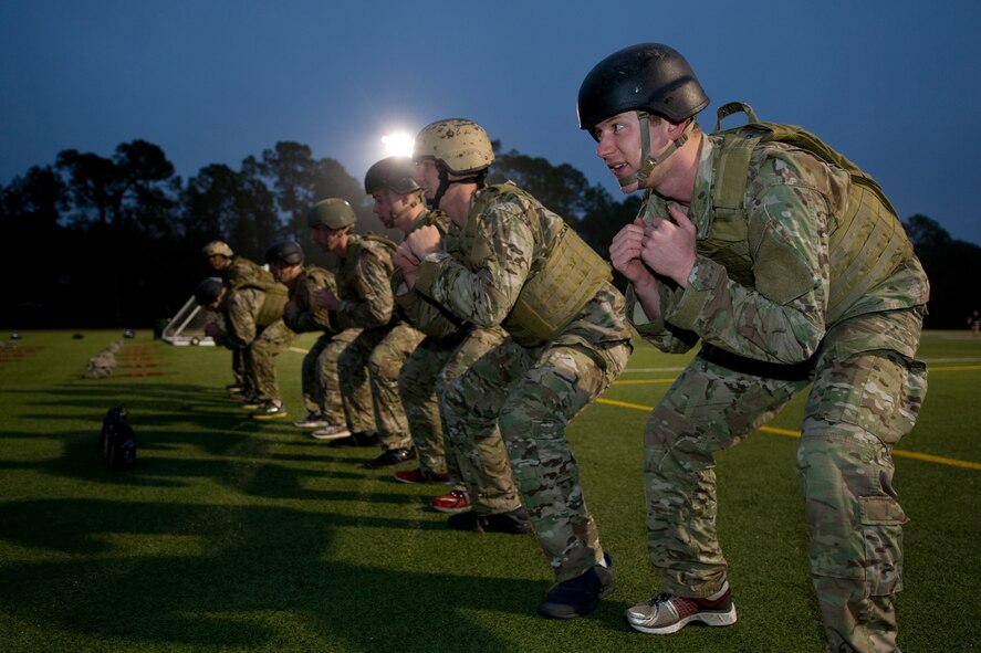 Tactical Air Control Party candidates from Hawk Flight 94, Detachment 3, 342nd Training Squadron, squat on the track at Hurlburt Field, Fla., Feb. 4, 2014. TACP candidates of Hawk Flight 94 were waiting for their teammates to complete a lap around the track with a water can. (U.S. Air Force photo/Senior Airman Naomi Griego)