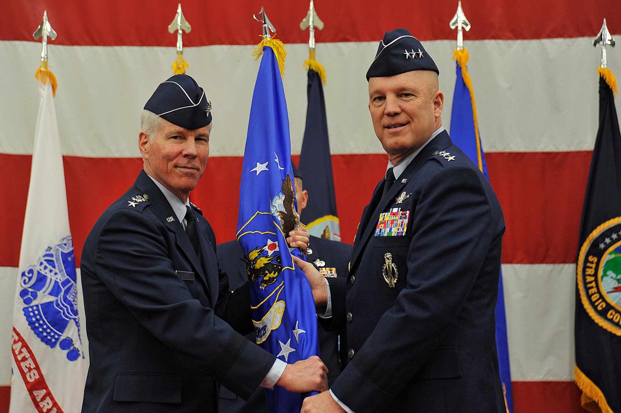 VANDENBERG AIR FORCE BASE, Calif. – General William Shelton, commander of Air Force Space Command, passes the 14th Air Force flag to Lt. Gen. John W. “Jay” Raymond, JFCC Space and 14th AF commander, in a change of command ceremony Jan. 31, 2014, at Vandenberg Air Force Base, Calif. Lt. Gen. Raymond succeeded Lt. Gen. Susan Helms, who led JFCC Space and 14th AF since January 2011.  (U.S. Air Force photo/Michael Peterson)