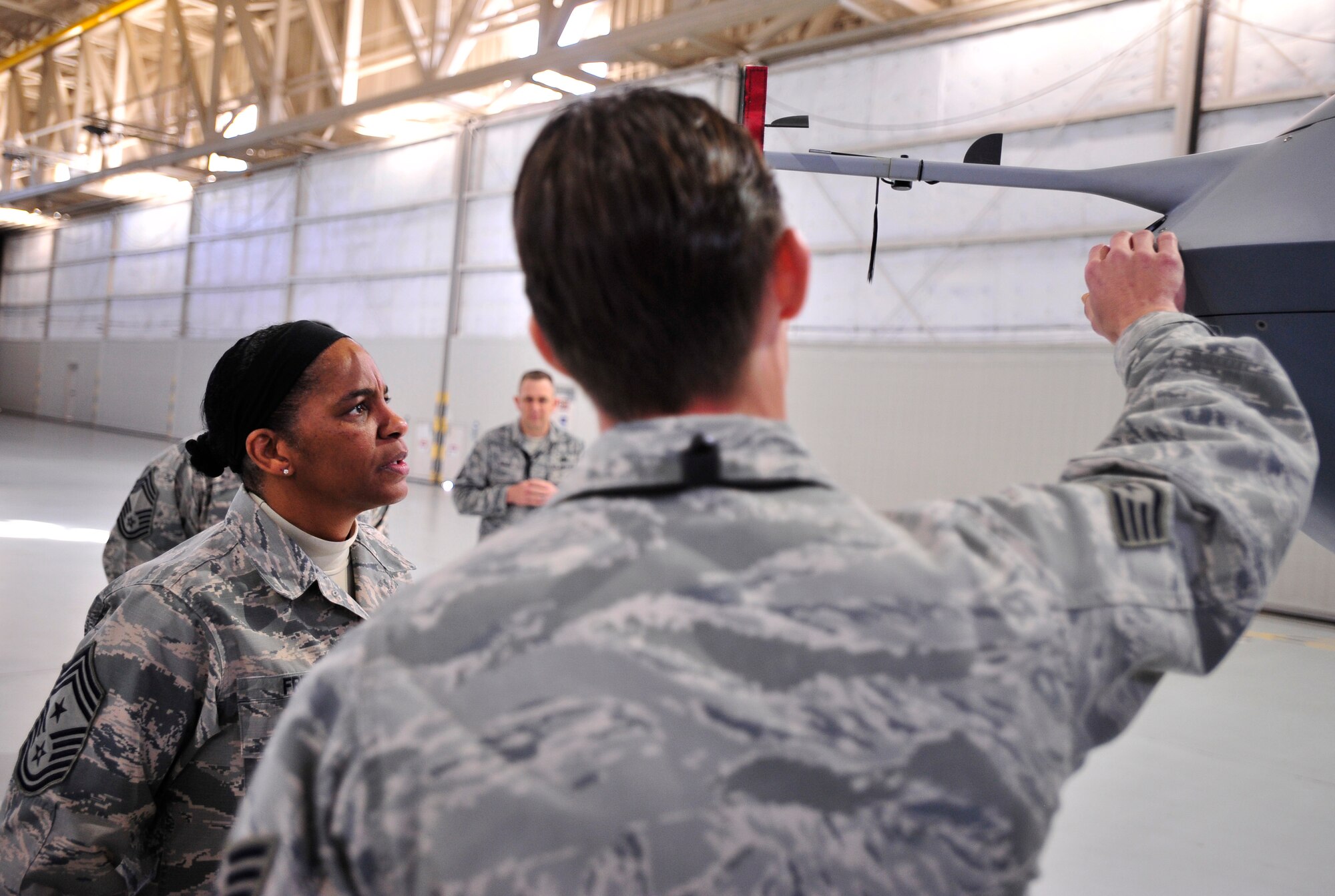 A 432nd Wing/432nd Air Expeditionary Wing Airman answers questions from Chief Master Sgt. Shelina Frey, U.S. Air Forces Central Command command chief, during her visit Jan. 9-10. Frey had an opportunity to meet with Airmen who conduct the Air Force’s ISR mission 24/7, 365 during her visit. (U.S. Air Force photo by Staff Sgt. N.B.)