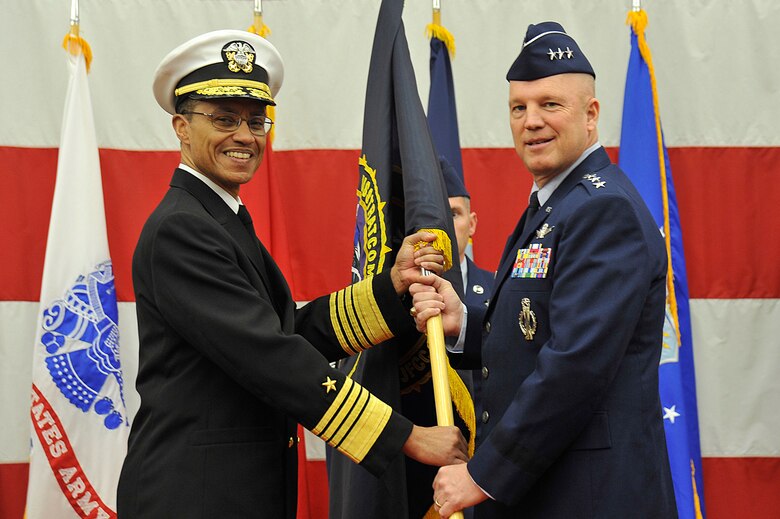 VANDENBERG AIR FORCE BASE, Calif. – Admiral Cecil Haney, commander of U.S. Strategic Command, passes the Joint Functional Component Command for Space flag to Lt. Gen. John W. “Jay” Raymond, JFCC Space and 14th Air Force commander, in a change of command ceremony Jan. 31, 2014, at Vandenberg Air Force Base, Calif. Lt. Gen. Raymond succeeded Lt. Gen. Susan Helms, who led JFCC Space and 14th AF since January 2011.  (U.S. Air Force photo/Michael Peterson)     