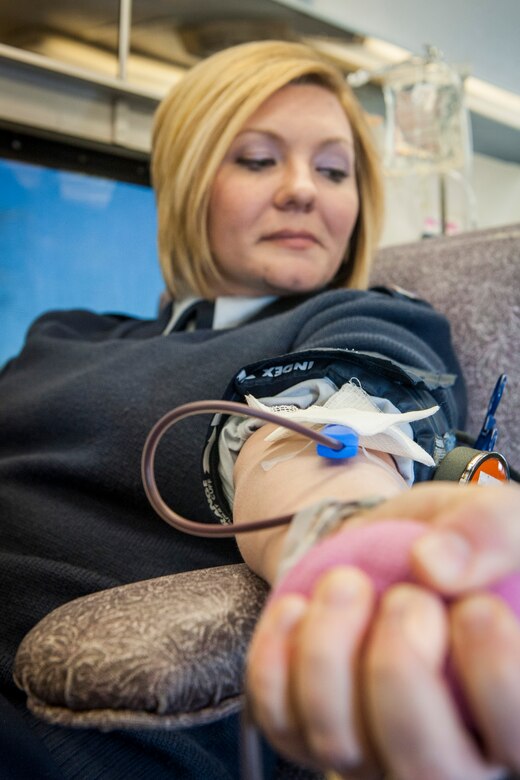 Staff Sgt. Seanna Hawley gives blood with the Inland Northwest Blood Center at Fairchild Air Force Base, Wash., Jan. 31, 2014. Every month the INBC sets up at locations such as the Exchange and Medical Group to offer service members the opportunity to give back to their community. Hawley is the 92nd Medical Support Squadron resource management NCO in charge and a Little Rock, Ark., native. (U.S. Air Force photo by Staff Sgt. Benjamin W. Stratton/Released)