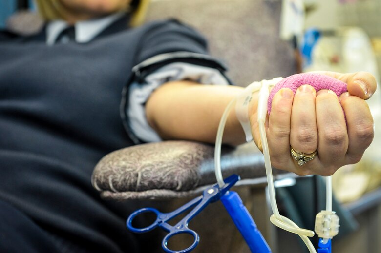 Staff Sgt. Seanna Hawley gives blood with the Inland Northwest Blood Center at Fairchild Air Force Base, Wash., Jan. 31, 2014. Every month the INBC sets up at locations such as the Exchange and Medical Group to offer service members the opportunity to give back to their community. Hawley is the 92nd Medical Support Squadron resource management NCO in charge and a Little Rock, Ark., native. (U.S. Air Force photo by Staff Sgt. Benjamin W. Stratton/Released)