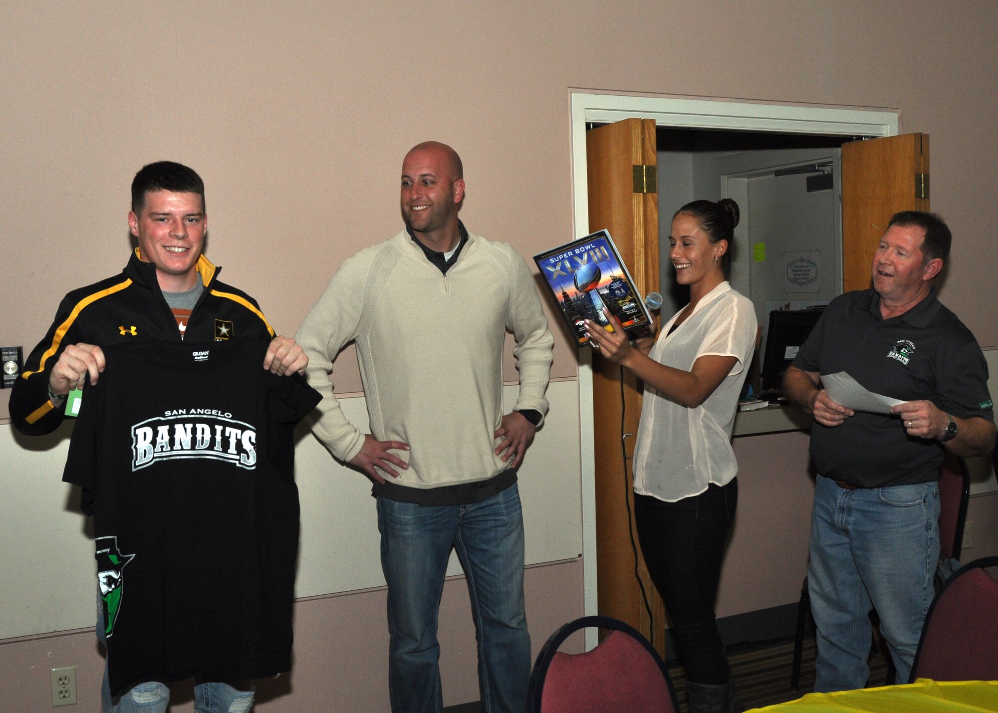 GOODFELLOW AIR FORCE BASE, Texas – Army Pvt. Quentin Kulish, Army 344th Military Intelligence Battalion student, wins the first quarter prize the San Angelo Bandits-sponsored during the Super Bowl XLVIII party at the Event Center Feb. 2. Kulish predicted the first quarter score correctly and received a Bandits t-shirt, gift certificate and a Super Bowl XLVII magazine. (U.S. Air Force photo/ Senior Airman Joshua Edwards)